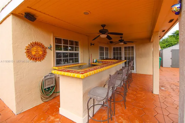 a front view of a house with swimming pool and porch