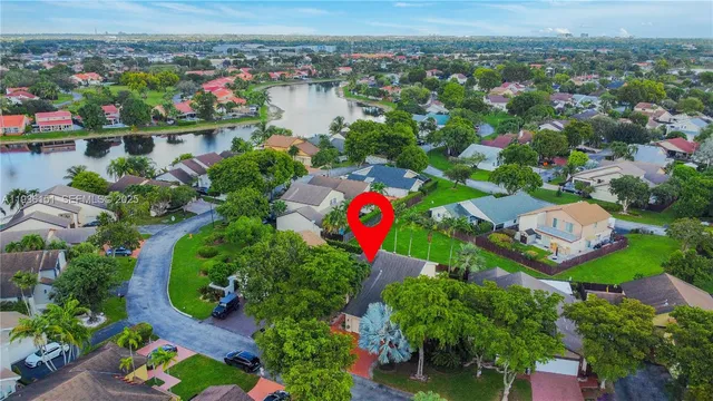 an aerial view of lake and residential houses with outdoor space
