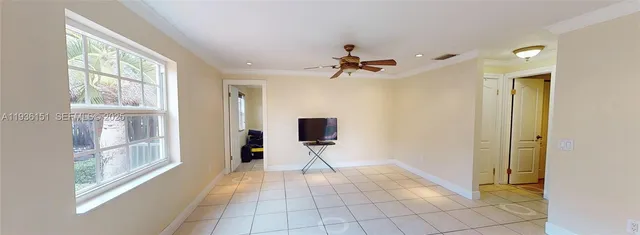 a view of a hallway with windows and chandelier