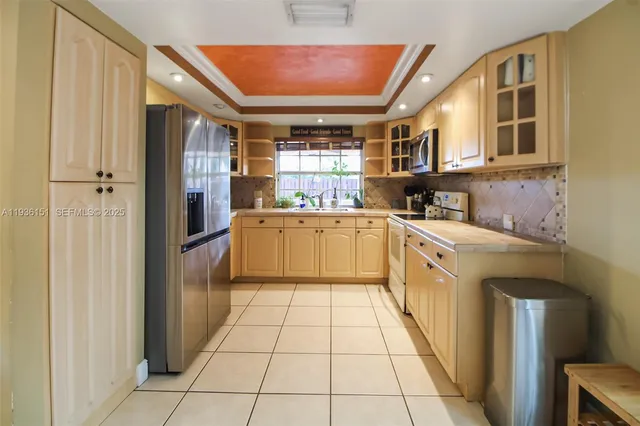 a kitchen with stainless steel appliances granite countertop a refrigerator and a sink