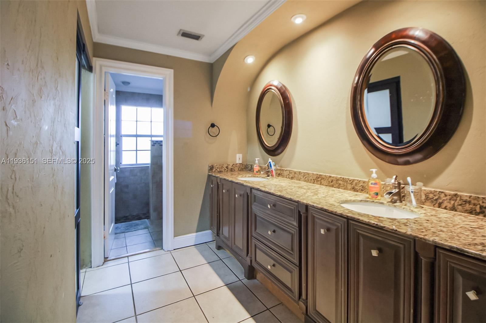 4235 Southwest 148th Place Miami, FL 33185 - Photo 9 of 23 a bathroom with a double vanity sink and a mirror