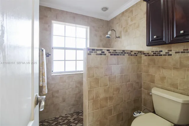 a bathroom with a toilet sink and shower