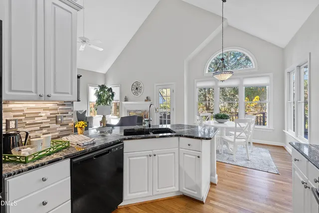 a living room with furniture a fireplace and a large window