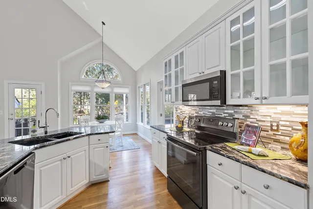 a living room with fireplace furniture and a wooden floor