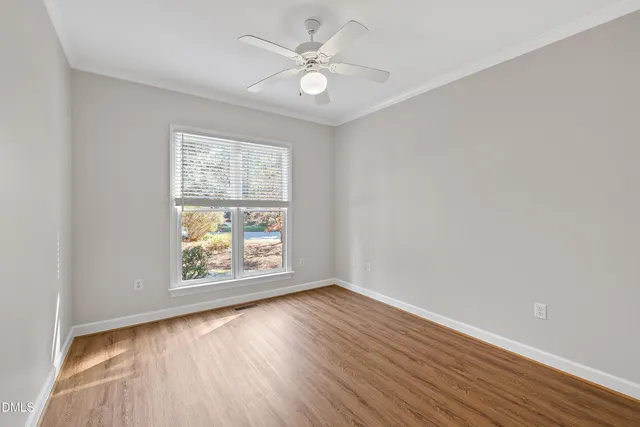a bathroom with a toilet sink vanity granite and shower