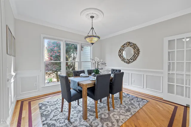 a living room with furniture a rug and a large window