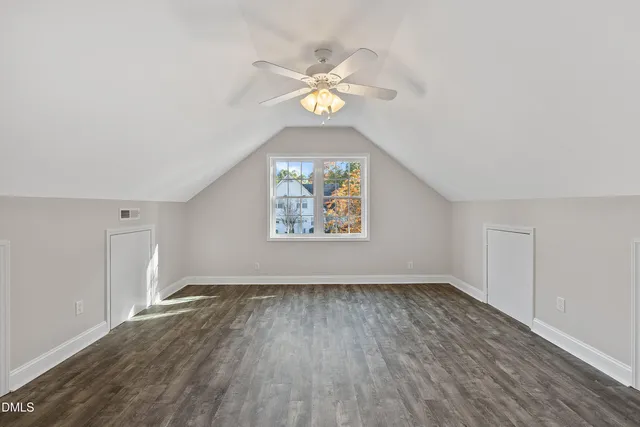 a front view of a house with a yard and tree s