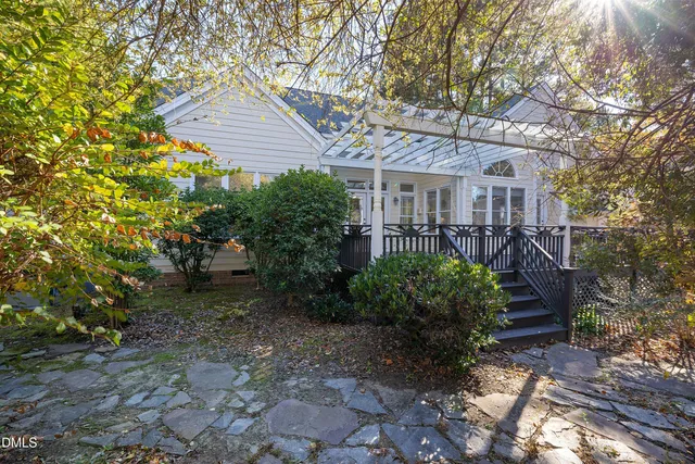 a view of a swimming pool with a yard and sitting area