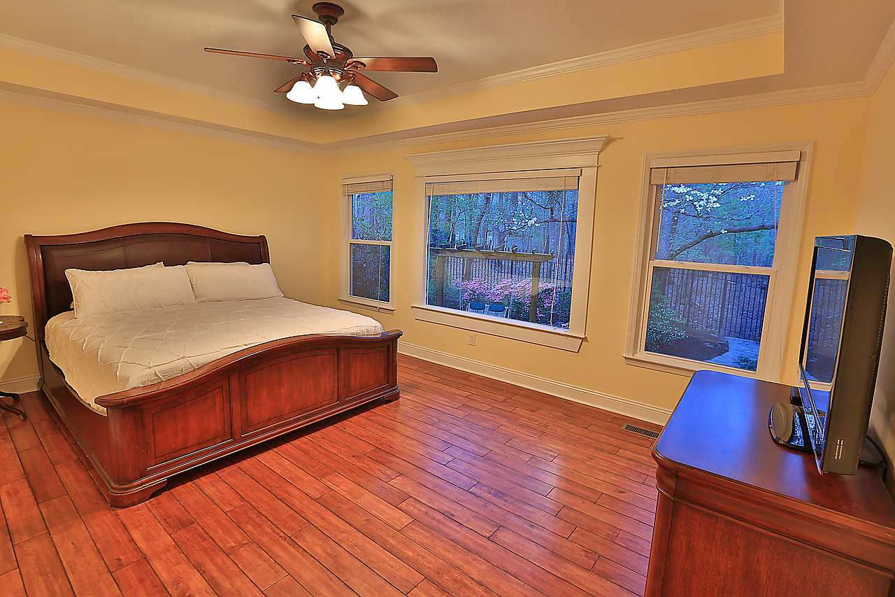 8536 Yucca Trail Raleigh, NC 27615 - Photo 5 of 23 Hardwood floors, trey ceiling and 3 large picture windows over looking the garden and nature park. downstairs mas