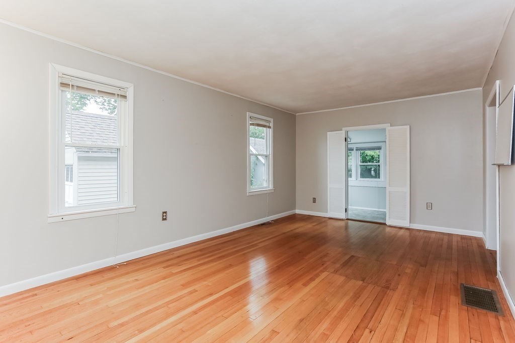 14 Bentley Street Springfield, MA 01108 - Photo 3 of 12 a view of an empty room with wooden floor and a window