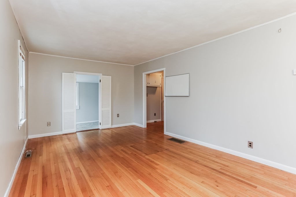 14 Bentley Street Springfield, MA 01108 - Photo 4 of 12 a view of an empty room with wooden floor and a window