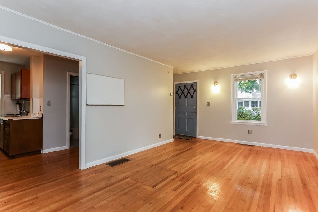 14 Bentley Street Springfield, MA 01108 - Photo 5 of 12 a view of empty room with wooden floor and fan