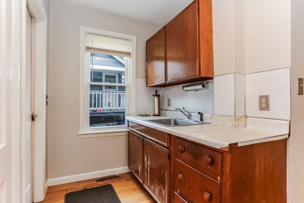 14 Bentley Street Springfield, MA 01108 - Photo 6 of 12 a kitchen with a sink stove and microwave