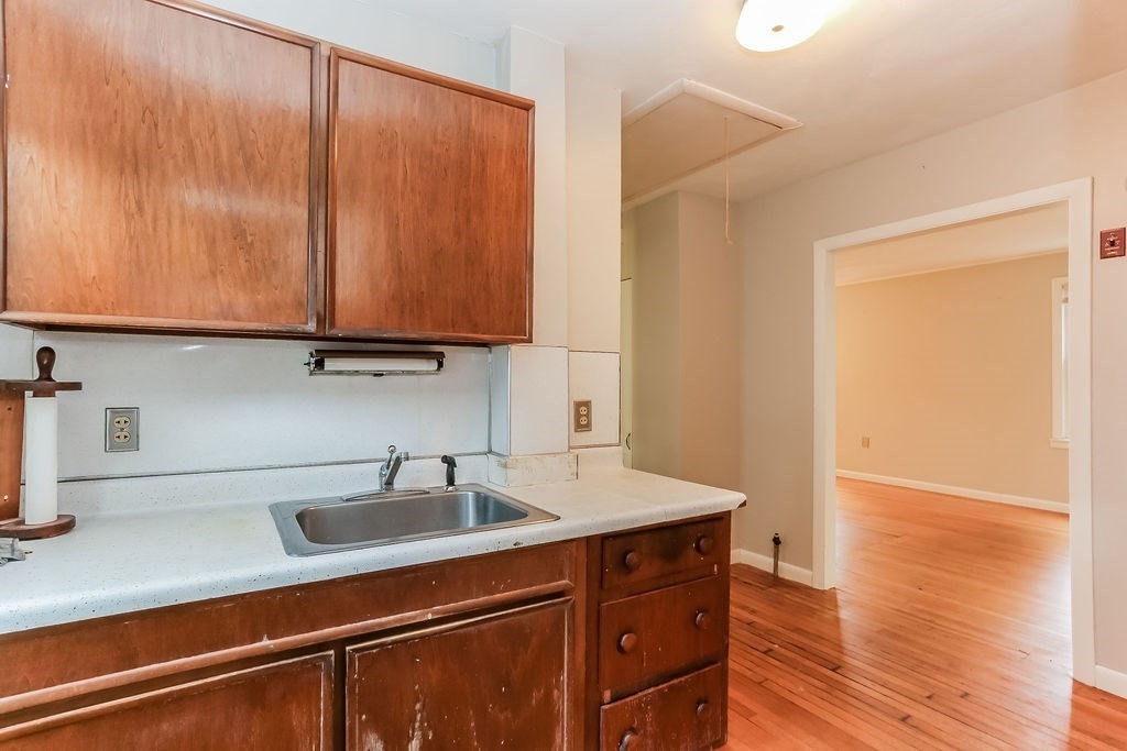 14 Bentley Street Springfield, MA 01108 - Photo 7 of 12 a kitchen with a sink and cabinets