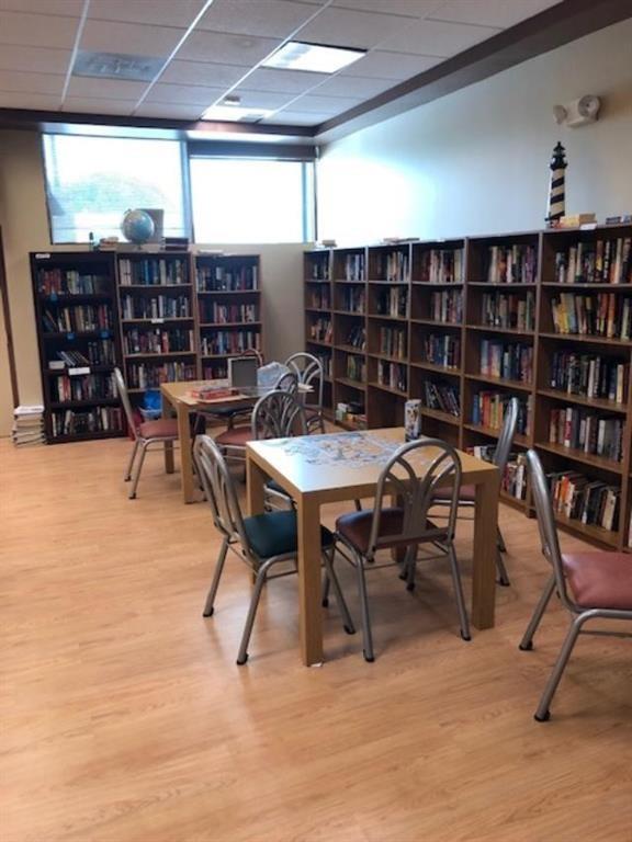 7300 Northwest 5th Court, Unit 101 Margate, FL 33063 - Photo 14 of 14 a dining room with furniture and a book shelf