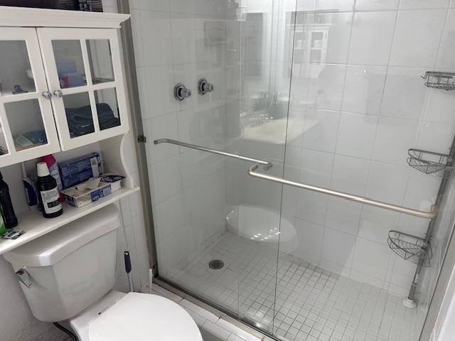 7300 Northwest 5th Court, Unit 101 Margate, FL 33063 - Photo 4 of 14 a bathroom with a toilet and a shower