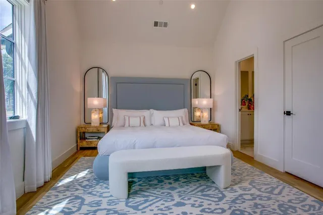 a bedroom with a bed and wooden floor