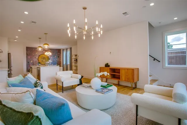 a living room with furniture a chandelier and a fireplace