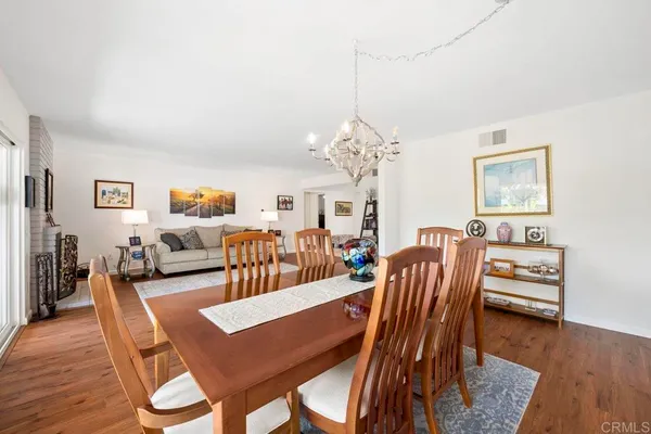 a dining room with furniture a rug and wooden floor