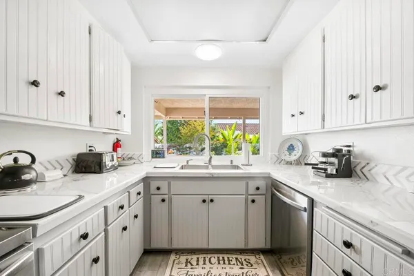 a kitchen with sink cabinets and window