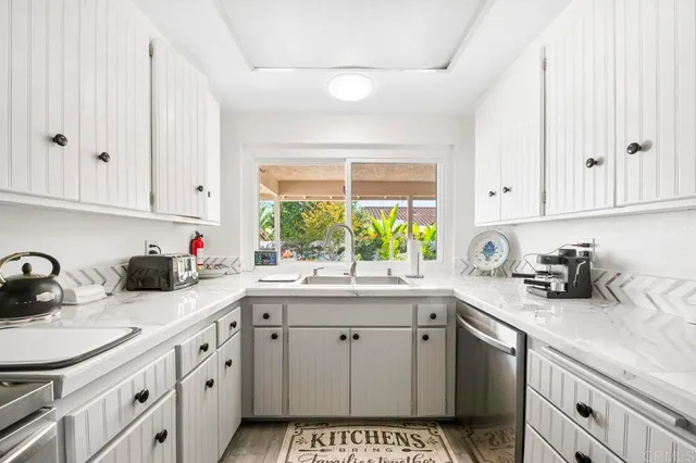a kitchen with sink cabinets and window