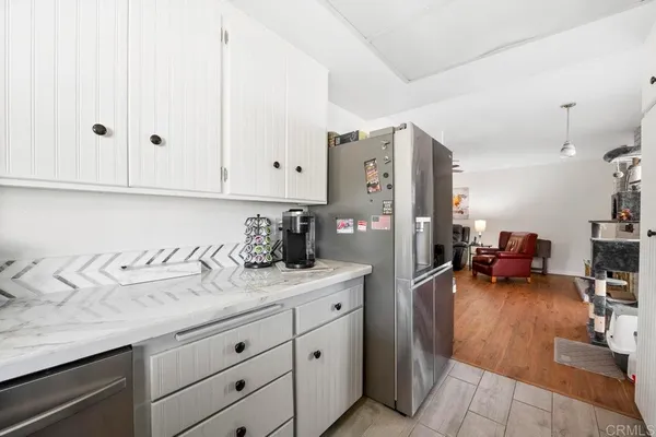 a view of a kitchen with furniture and wooden floor