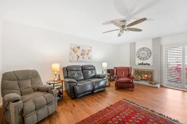 a living room with furniture a rug and a window