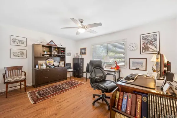 a view of a workspace with furniture and a window