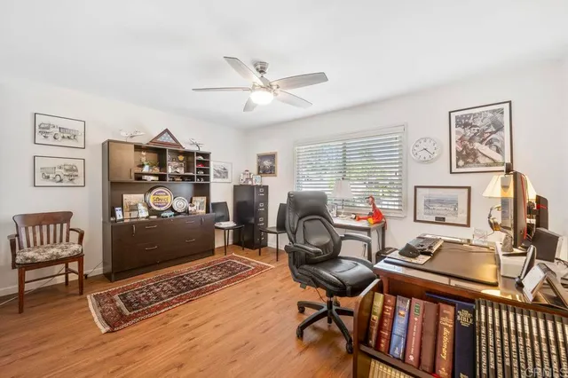a view of a workspace with furniture and a window