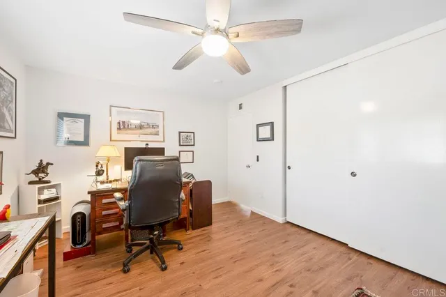 a view of a workspace with furniture and a window
