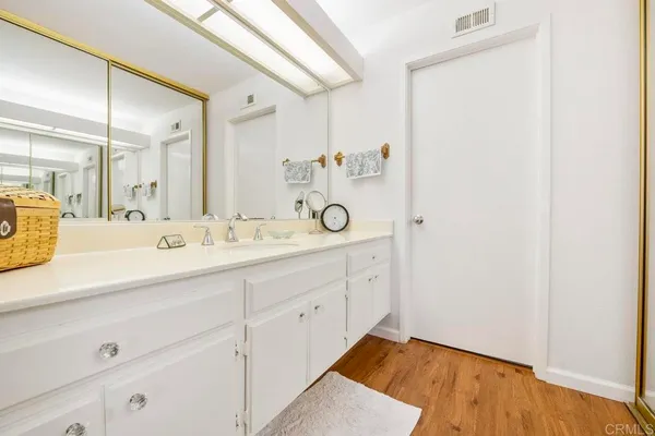 a spacious bathroom with a granite countertop sink a mirror and shower view