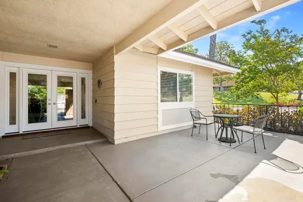a view of a patio with table and chairs and potted plants