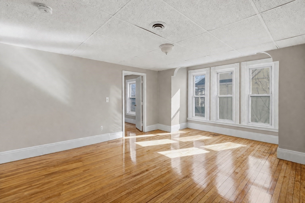 28 Prospect Street Brockton, MA 02301 - Photo 12 of 22 a view of empty room with wooden floor and fan