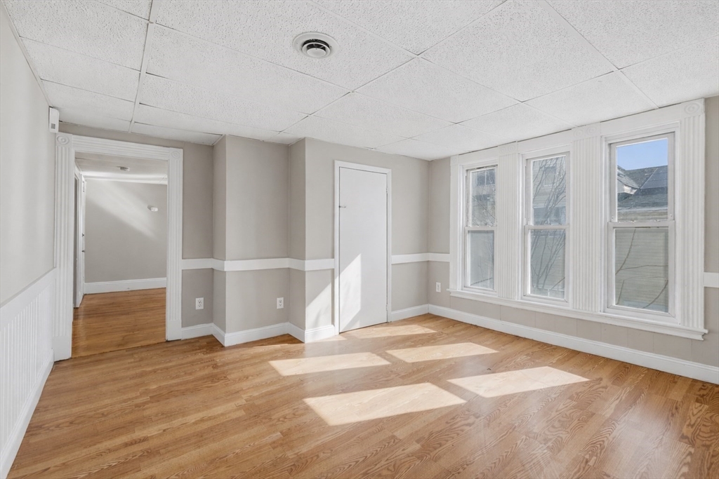 28 Prospect Street Brockton, MA 02301 - Photo 13 of 22 an empty space with wooden floor and windows