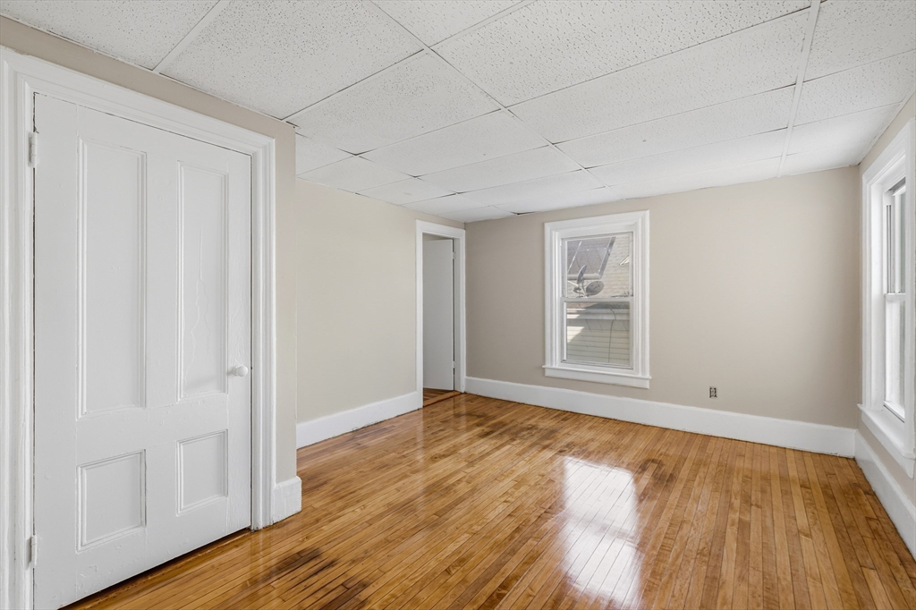 28 Prospect Street Brockton, MA 02301 - Photo 14 of 22 a view of an empty room with wooden floor and a window