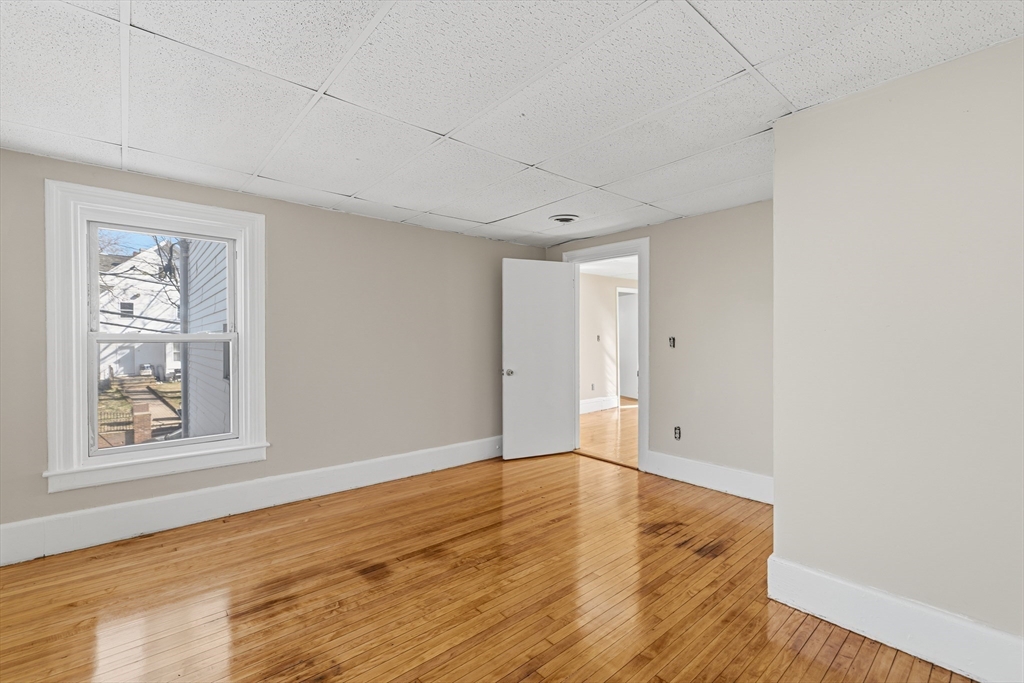 28 Prospect Street Brockton, MA 02301 - Photo 15 of 22 a view of an empty room with wooden floor and a window