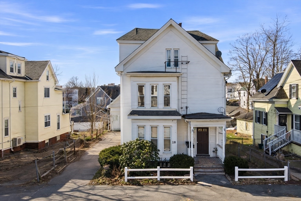 28 Prospect Street Brockton, MA 02301 - Photo 3 of 22 a front view of a house with a tree