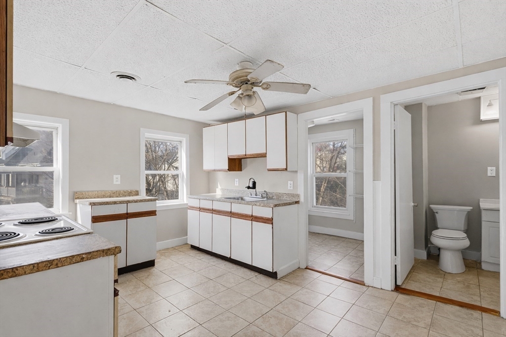 28 Prospect Street Brockton, MA 02301 - Photo 6 of 22 a kitchen with white cabinets and sink
