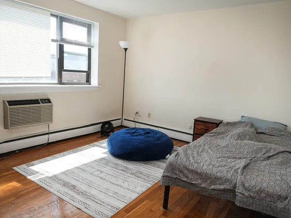 a bedroom with bed and window