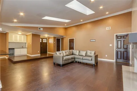 a kitchen with stainless steel appliances a refrigerator and wooden floor