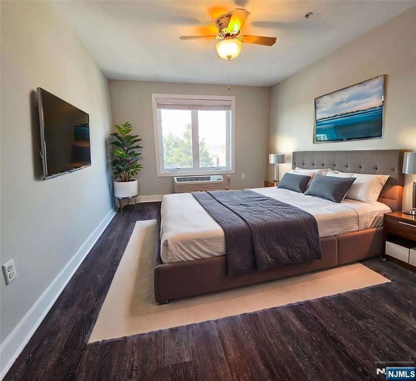 235 Ridge Road North Arlington, NJ 07031 - Photo 6 of 13 a bedroom with a large bed and a flat screen tv