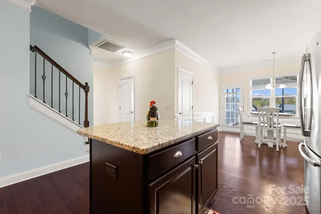 a room with lots of counter space and wooden floor