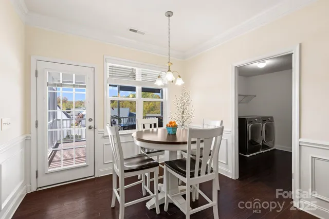 a view of a dining room with furniture wooden floor and a floor to ceiling window