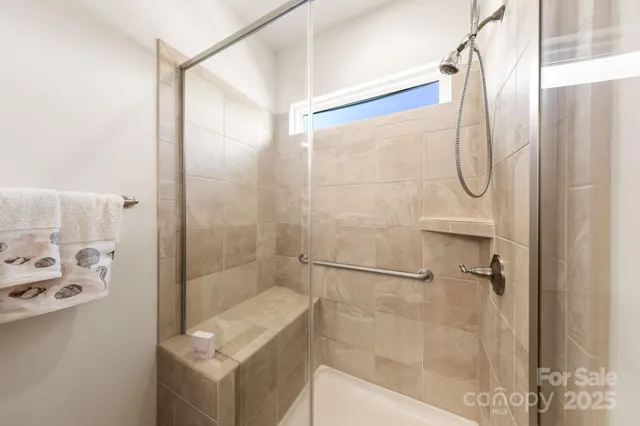 a bathroom with a glass shower door