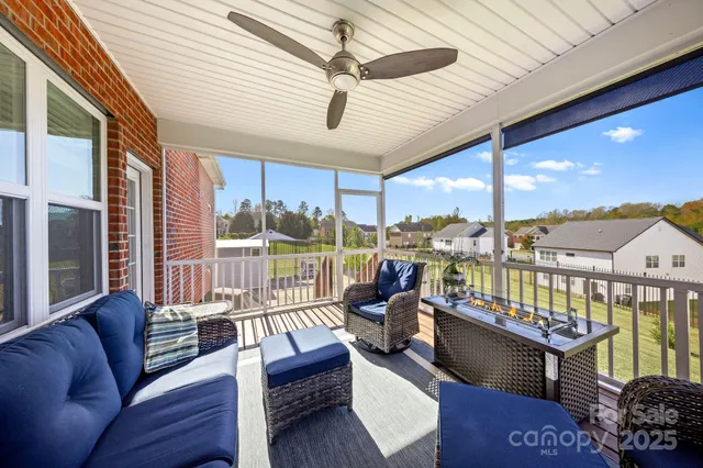 a view of a house with swimming pool and sitting area