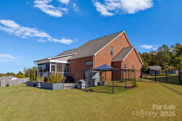 a view of a house with swimming pool and sitting area
