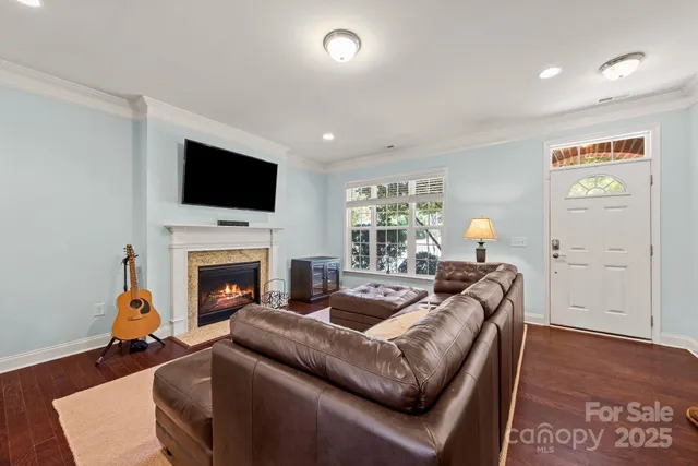 a living room with furniture a fireplace and a flat screen tv