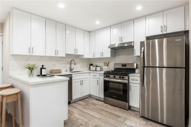 a kitchen with a stove top oven sink and refrigerator
