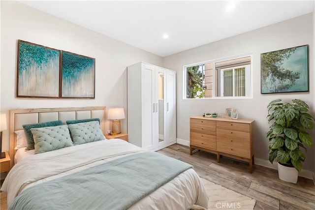 a bedroom with a bed and furniture with window