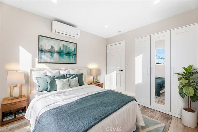 a bedroom with bed and wooden floor